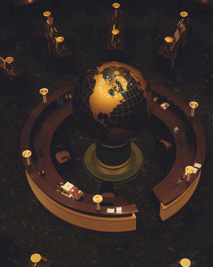 Aerial view of a glowing globe at a circular reception desk with ambient lighting.